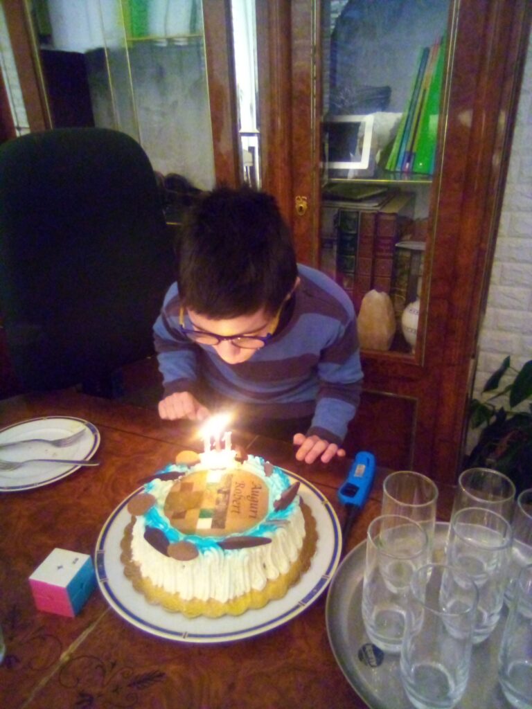 Photo of me in 2021 blowing out the candles on my birthday cake